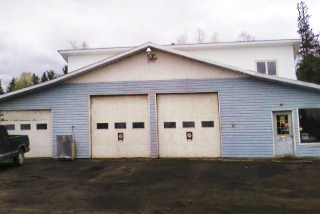 the front of a mechanic garage with two doors